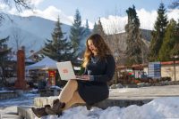 Una mujer realiza teletrabajo en un paraje idílico